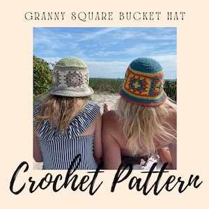 May include: Two people wearing crocheted bucket hats with colourful granny square patterns. The hats are green and blue with pink, orange, and yellow accents. The people are sitting on a sandy beach with a blue sky and white clouds in the background. The text "Granny Square Bucket Hat Crochet Pattern" is at the top of the image.