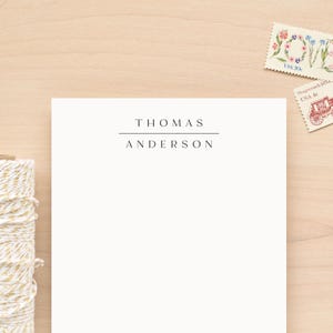 May include: White stationery with a simple, minimalist design. The name "THOMAS ANDERSON" is printed in black at the top of the page.