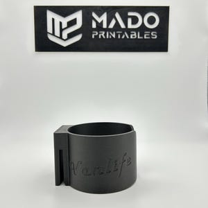 May include: A gray 3D printed cup holder with the word "Vanlife" printed on the side.