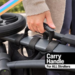 May include: A black stroller carry handle featuring a textured grip and adjustable fabric straps that wrap around the frame. The handle is labeled with the text Carry Handle For ALL Strollers in white font against a black rectangular background.