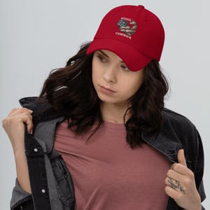 May include: Red baseball cap with an American flag heart design and the text "Setback Comeback".