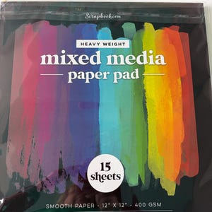 May include: A black package of mixed media paper pad with a colorful rainbow design. The package reads "mixed media paper pad" and "15 sheets". The paper is 12" x 12" and 400 GSM.