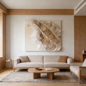 May include: A contemporary living room featuring a neutral colour scheme. A large abstract artwork made of layered paper and fluffy white elements hangs above a beige sofa. A round wooden coffee table sits on a patterned rug.