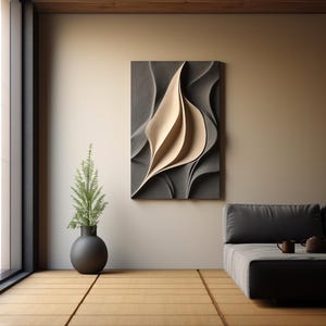 May include: A modern abstract wall sculpture featuring a beige leaf-like design on a grey background. The sculpture is hanging on a beige wall in a room with a grey sofa and a potted plant.