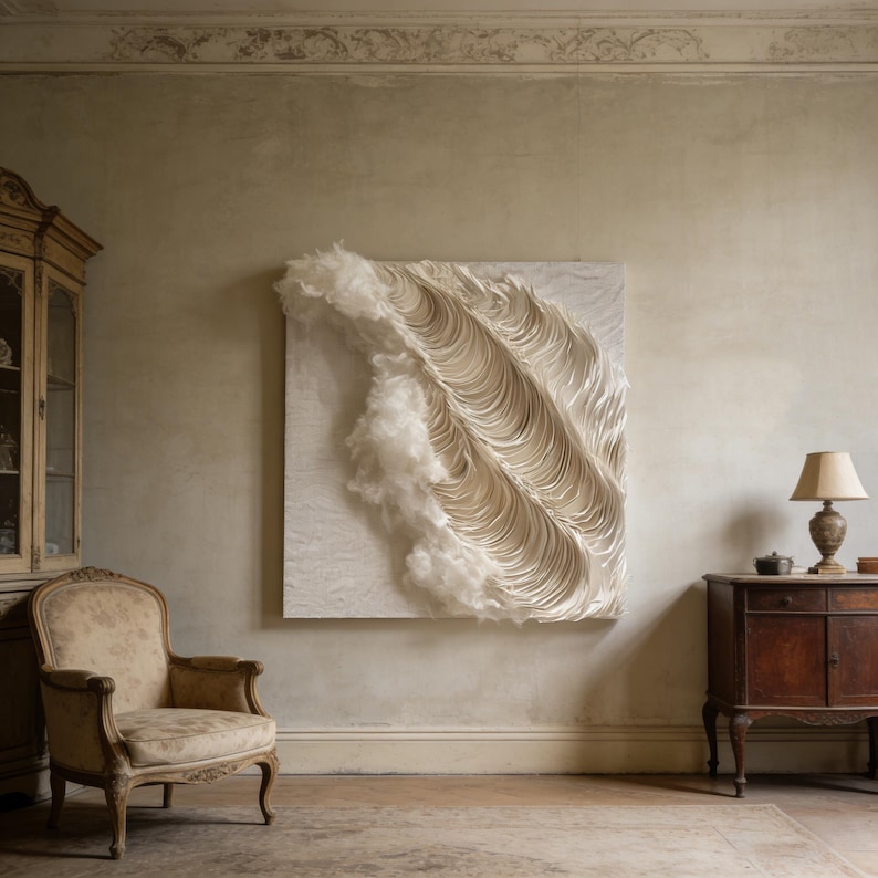 May include: A large, square, abstract wall art piece with a textured, layered design in shades of white and cream. The artwork features a wave-like pattern with a fluffy, cloud-like element. The piece is mounted on a neutral-coloured wall.