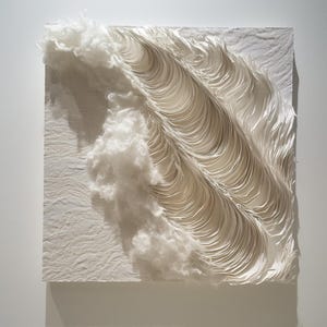 May include: A square, off-white artwork with a textured surface and a layered, wave-like design. The piece combines textured fabric and sculpted paper-like elements, creating a 3D effect. Fluffy, cloud-like forms add depth and contrast to the artwork.