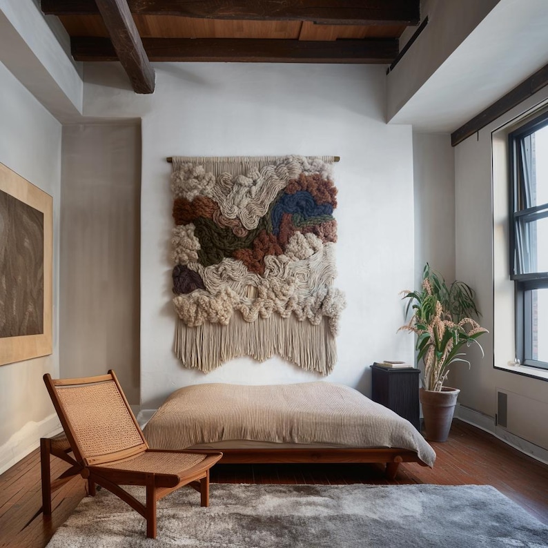 May include: A bedroom scene featuring a woven wall hanging with beige, brown, and blue textures. A wooden chair with a woven seat sits near a bed with a beige cover. A potted plant and a window are also visible.