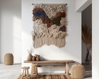 May include: A large, textured wall hanging with a neutral color palette of beige, brown, and blue. Below, a wooden bench, small stools, and a striped rug create a cozy space. Woven basket and vases add to the natural, earthy aesthetic.