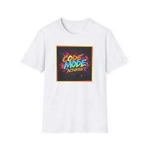 May include: A white t-shirt featuring the text "CODE MODE ACTIVATED" in a colourful design. The graphic is set within a square with a black background and a yellow border. The text uses shades of orange, blue, and green.