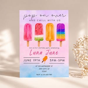 May include: A rectangular birthday invitation card featuring a watercolour background transitioning from purple to pink to blue. It displays four illustrated ice lollies, the text "pop on over AND CHILL WITH US", "Luna June", and event details.