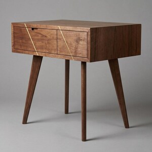 May include: A mid-century modern style nightstand with two drawers. The nightstand is made of dark brown wood with gold accent lines and has four angled legs. The nightstand measures approximately 24 inches wide, 16 inches deep, and 24 inches high.