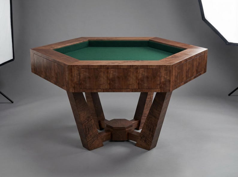 May include: A large, octagonal wooden game table with a green felt playing surface. The table has a rich, dark wood grain finish and sturdy, angled legs. The table is designed for games like poker or board games.