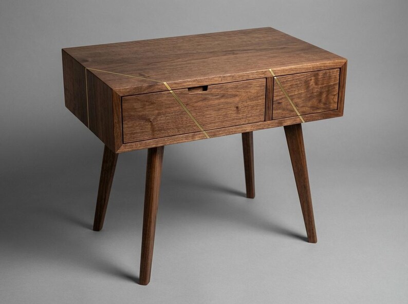 May include: A mid-century modern style wooden nightstand with a drawer and a cabinet. The nightstand is made of dark brown wood with brass accents and has four tapered legs. The drawer has a small, rectangular handle.