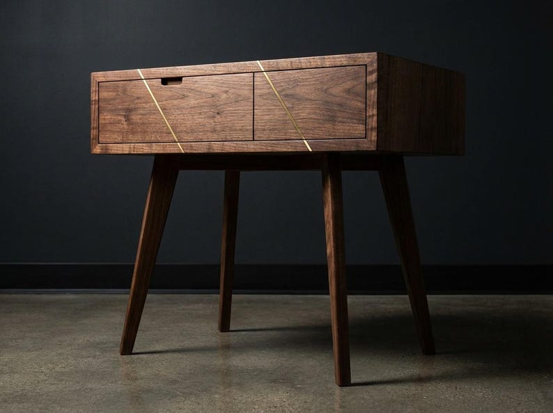 May include: A mid-century modern wooden nightstand with two drawers and angled legs. The nightstand is made of dark wood and features brass accents. The drawers have a simple, minimalist design, and the legs are tapered.