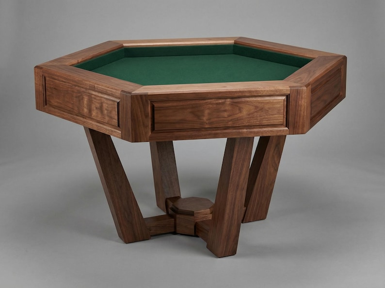 May include: A solid wood, octagonal game table with a green felt playing surface. The table has a rich, dark brown finish and features decorative drawer fronts. The legs are angled and provide a sturdy base for the table.