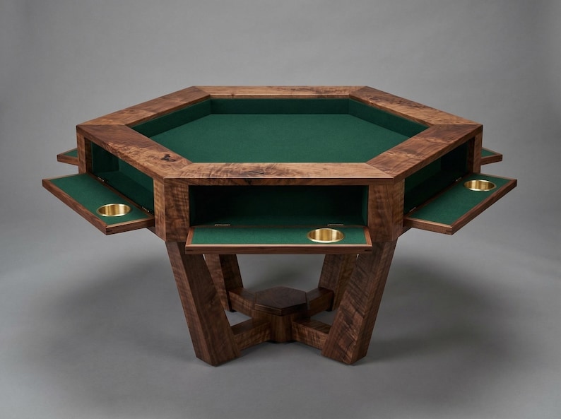 May include: A wooden octagonal poker table with a green felt playing surface. The table has pull-out trays with brass cup holders and is supported by a sturdy, angled base. The wood has a rich, dark finish.