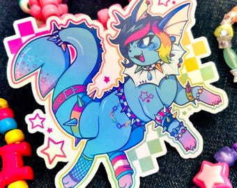 May include: A die-cut sticker featuring a blue, anthropomorphic creature with rainbow-colored hair, wearing a spiked collar, wristbands, and a checkered belt. The character has a fish-like tail, star accents, and fishnet leg details. Text reads CAKEBOPPOP.
