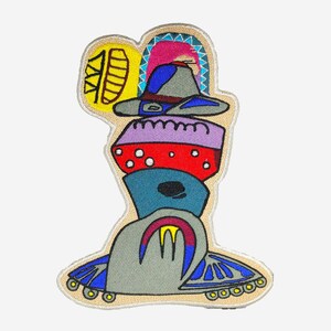 May include: Embroidered patch featuring a whimsical, stacked design. The patch showcases a series of colorful, abstract shapes, including a hat, a red dotted shape, and a blue form. The edges are outlined in a tan color, with blue and yellow accents.