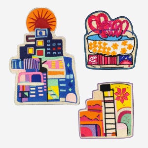 May include: Three embroidered patches with colorful, abstract designs. One features a cityscape with a sun, another depicts a container with flowers and ribbons, and the third shows a ladder and a flower.