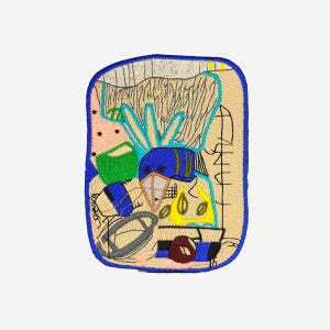 May include: Embroidered patch with a blue border featuring an abstract design. The patch includes shapes in blue, green, yellow, and pink, with black and white line details. The background is a light tan color.