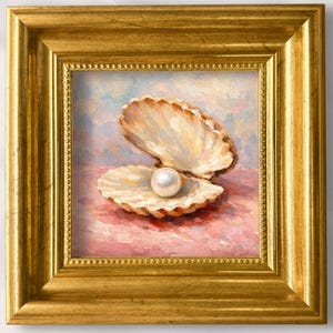 May include: A square, gold-framed painting featuring a pearl nestled in an open seashell. The artwork is hand-painted, with the text "Lynn" and "100% Hand-Painted" visible. The background is a soft, light pink and blue.
