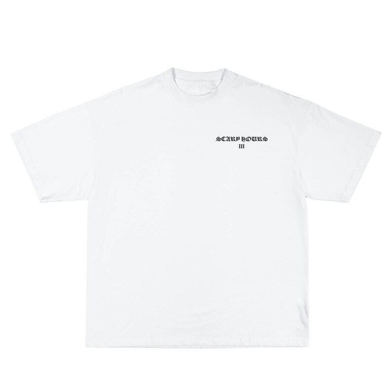 May include: A white t-shirt with short sleeves. The shirt features the text "SCARF HOURS III" in a dark, stylized font centered on the chest. The shirt is made of a soft, opaque material.