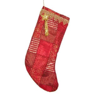 May include: Red Christmas stocking with gold accents. The stocking features a patchwork design with gold stripes and swirls. A gold star and tassel hang from the top, and the top edge is trimmed with gold lace. The stocking is hanging from a thin gold string.