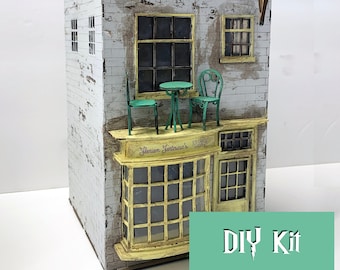 May include: A DIY kit for building a miniature ice cream shop with a white brick facade, green awning, and a sign that reads "Glorium Jentlescue's Ice Cream Garden".