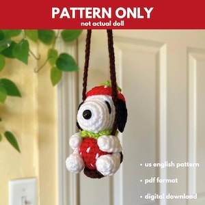 May include: Crochet pattern for a stuffed toy dog wearing a strawberry hat and sitting on a swing. The pattern is in PDF format and is available for digital download. The pattern is written in US English.