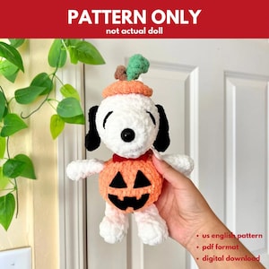 May include: A white and black crochet Snoopy doll wearing an orange pumpkin costume and hat. The doll has black eyes and ears. The text "PATTERN ONLY" is at the top. The text "not actual doll" is below it. The text "us english pattern", "pdf format", and "digital download" are at the bottom.