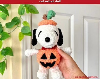 May include: A crochet Snoopy doll in white and black, dressed in an orange pumpkin costume and hat. The doll has black eyes and ears. The text "PATTERN ONLY" is at the top. The text "not actual doll" is below it. The text "us english pattern", "pdf format", and "digital download" are at the bottom.