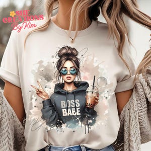 May include: A white t-shirt with a graphic of a woman wearing sunglasses and a hoodie with the text "Boss Babe". The woman is holding a cup of boba tea.