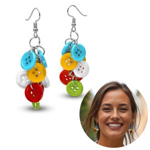 May include: Colorful button earrings with silver-tone hooks. Each earring features a cluster of vibrant buttons in various colors, including blue, yellow, red, white, and green. The buttons are attached with small silver rings, creating a playful and unique accessory.