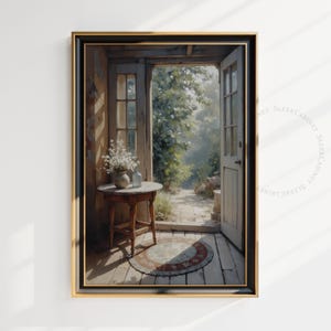 May include: A framed painting depicting a rustic doorway opening onto a garden. The doorway is open, allowing sunlight to flood the space. A small table with a vase of white flowers and two glass bottles is positioned within the doorway. A patterned rug is laid on the wooden floor.