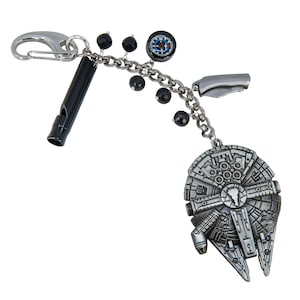 May include: A silver keychain with a whistle, a small compass, a folding knife, and a Millennium Falcon charm. The keychain also features a chain with black beads and a clasp for attaching to a bag or belt loop.