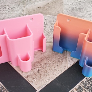 May include: Two wall-mounted organizers, one pink and one with a gradient of peach to blue. Both have three compartments.