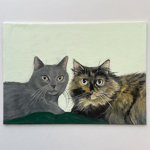 May include: A rectangular canvas painting featuring two cats. One cat is gray, the other is a mix of brown, black, and tan. Both cats are looking directly at the viewer against a light green background.