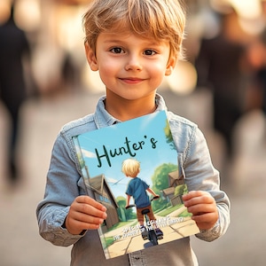 May include: A young boy holds a blue book with the title "Hunter's Special Beginnings: The Journey of the Little Embryo". The book features an illustration of a young boy riding a bicycle.