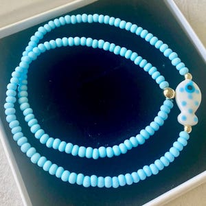Ceramic Fish Beaded Charm necklaces. Made with Multi Color Ceramic Fish,Gemstones,Shell beads,seed beads & 14k Gold filled accent beads.