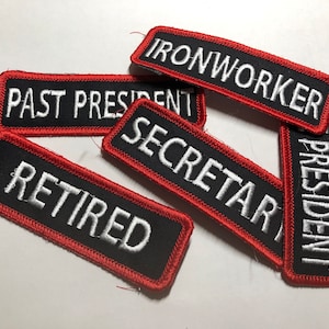 May include: Six black and red embroidered patches with white text. The patches read "Ironworker", "Past President", "Secretary", "President", "Retired".