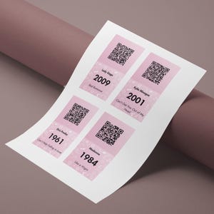 May include: A sheet of paper with four pink and white rectangular designs, each featuring a QR code and text. The text includes artist names like Lady Gaga and Madonna, along with song titles and years such as 2009 and 1984.