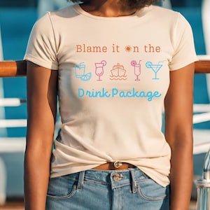May include: A beige t-shirt with the text "Blame it on the Drink Package" and a sun, a cruise ship, and four drink icons.
