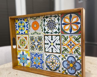 May include: A wooden serving tray with a colorful tile design. The tiles feature a variety of geometric patterns and floral motifs in shades of blue, green, yellow, orange, and white.