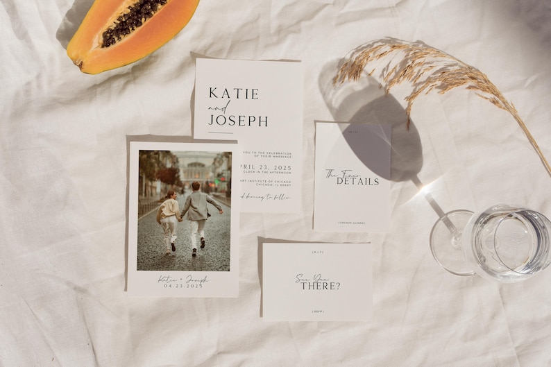 May include: Wedding invitation suite with a minimalist design. The invitation features a photo of a couple walking away from the camera. The text on the invitation reads "Katie and Joseph" and "April 23, 2023". The RSVP card reads "Save the Date?"