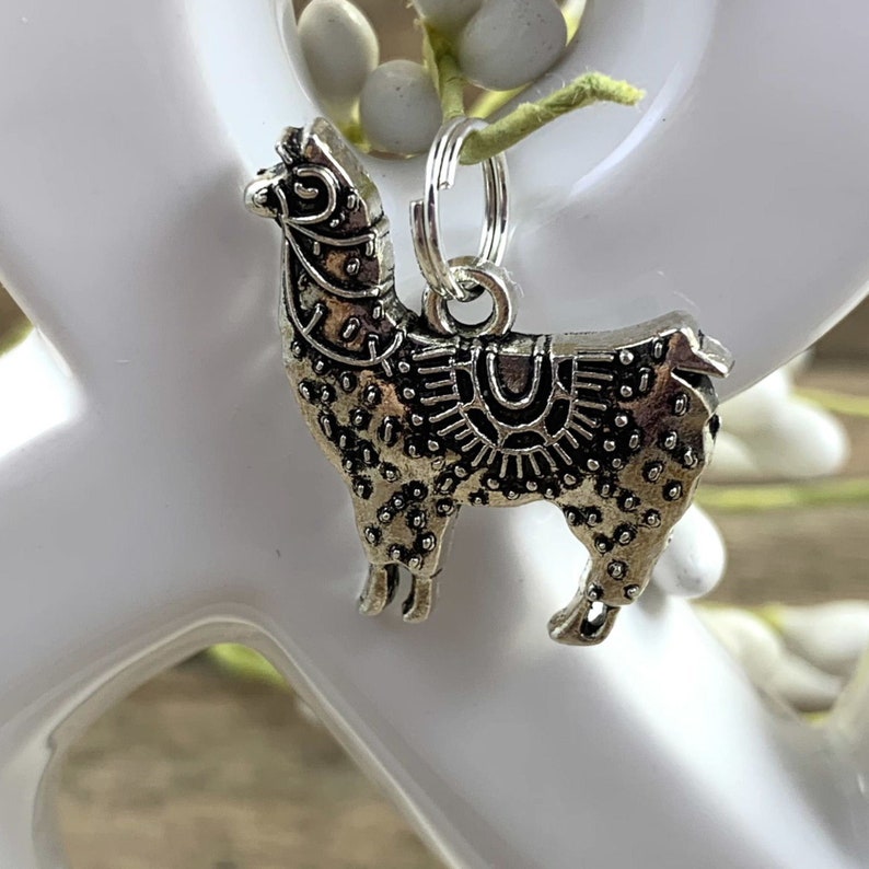 May include: Silver charm of a llama with intricate details, perfect for adding a touch of whimsy to a keychain or bracelet.