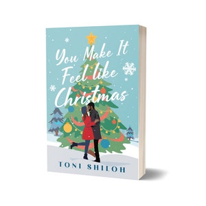 May include: A book titled "You Make It Feel Like Christmas" with a winter holiday theme. The cover features a couple embracing in front of a Christmas tree. The author's name, Toni Shiloh, is printed at the bottom.