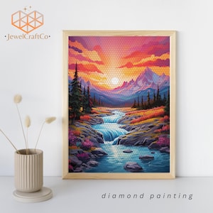 Puede incluir: Kit de pintura de diamantes con un paisaje de puesta de sol colorido con un río que fluye a través de un valle de montaña. La pintura representa un cielo vibrante con tonos rosados, naranjas y morados, y un río azul claro con una cascada. Las montañas están cubiertas de nieve y los árboles son verdes.