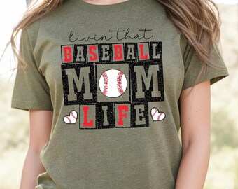 May include: Green t-shirt with the text "Livin' that Baseball Mom Life" in black and red letters with a baseball graphic.