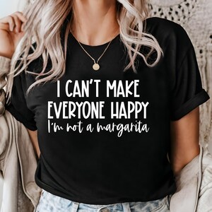 May include: Black t-shirt with white text that reads "I can't make everyone happy I'm not a margarita".
