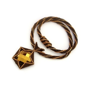 May include: A brown and gold beaded necklace with a large, faceted, gold-toned pendant.